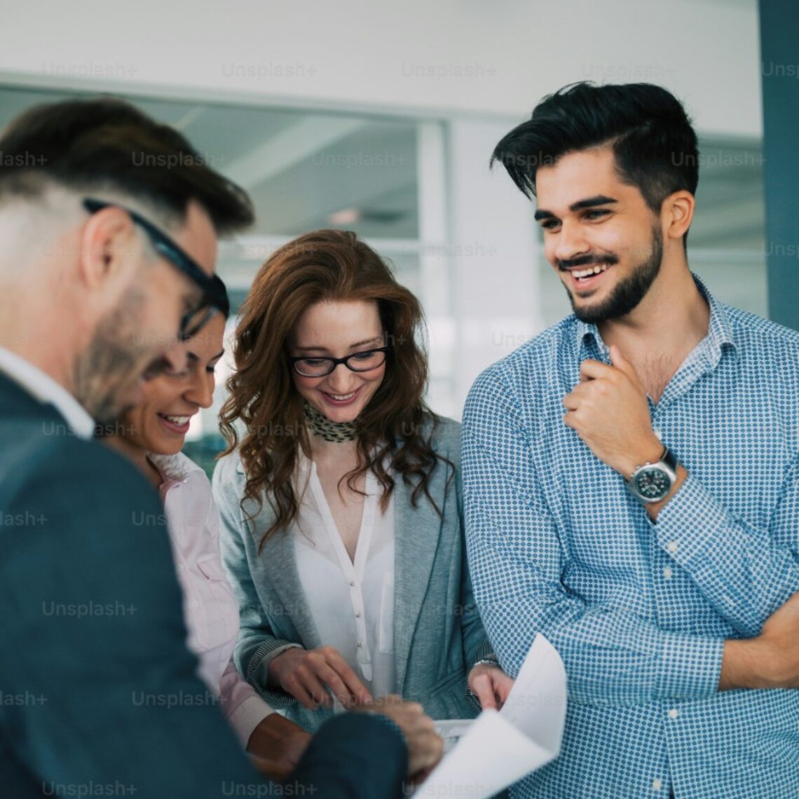 A group of young people smiling and talking.