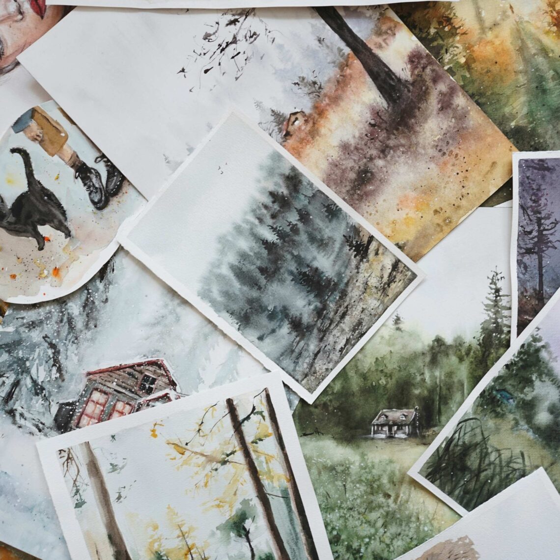 A stack of posters and paper paintings.