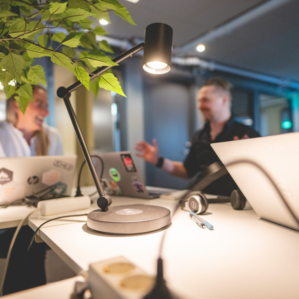 Laptops on a crowded desk.